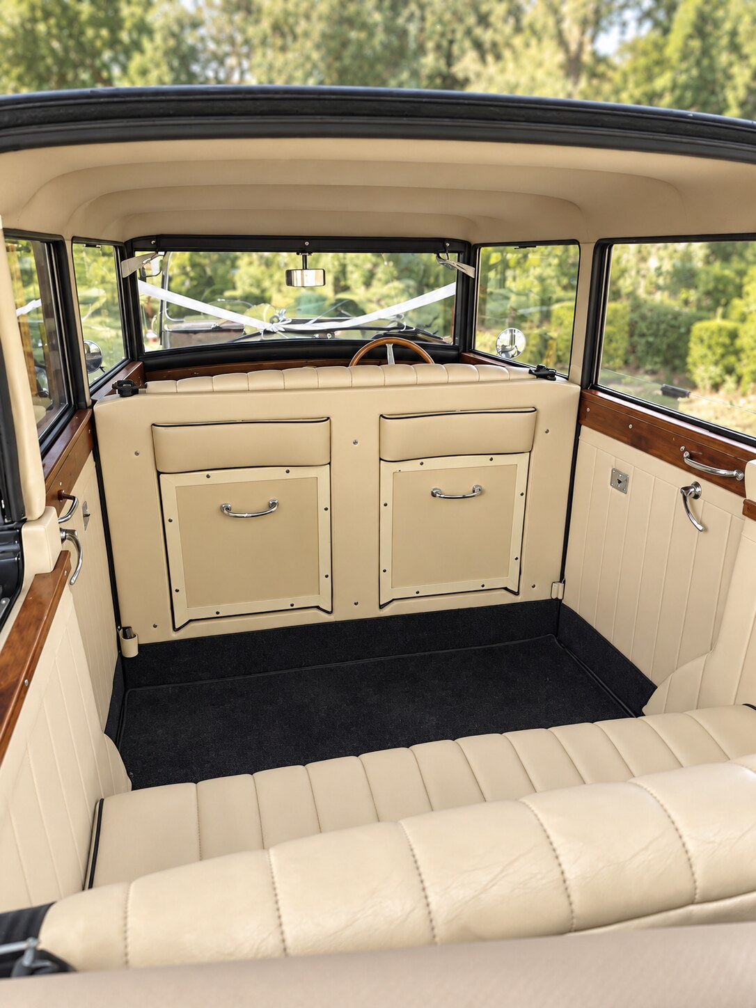 The Regent’s cream-upholstered passenger compartment with wood trim and an open roof